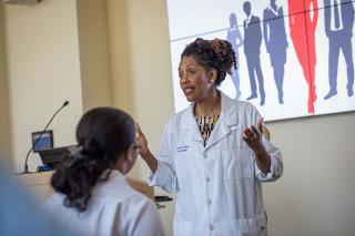 Faculty member providing instruction to a class.