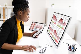 Women looking at graphs on her computers