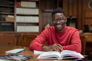 A Sociology student reading in the library