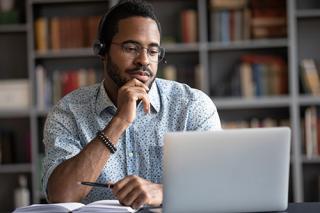 Male student watching webinar