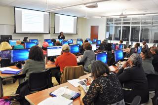 Faculty technology conference participants listen during a presentation